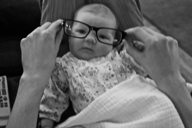 an image of woman combing the hair of her baby