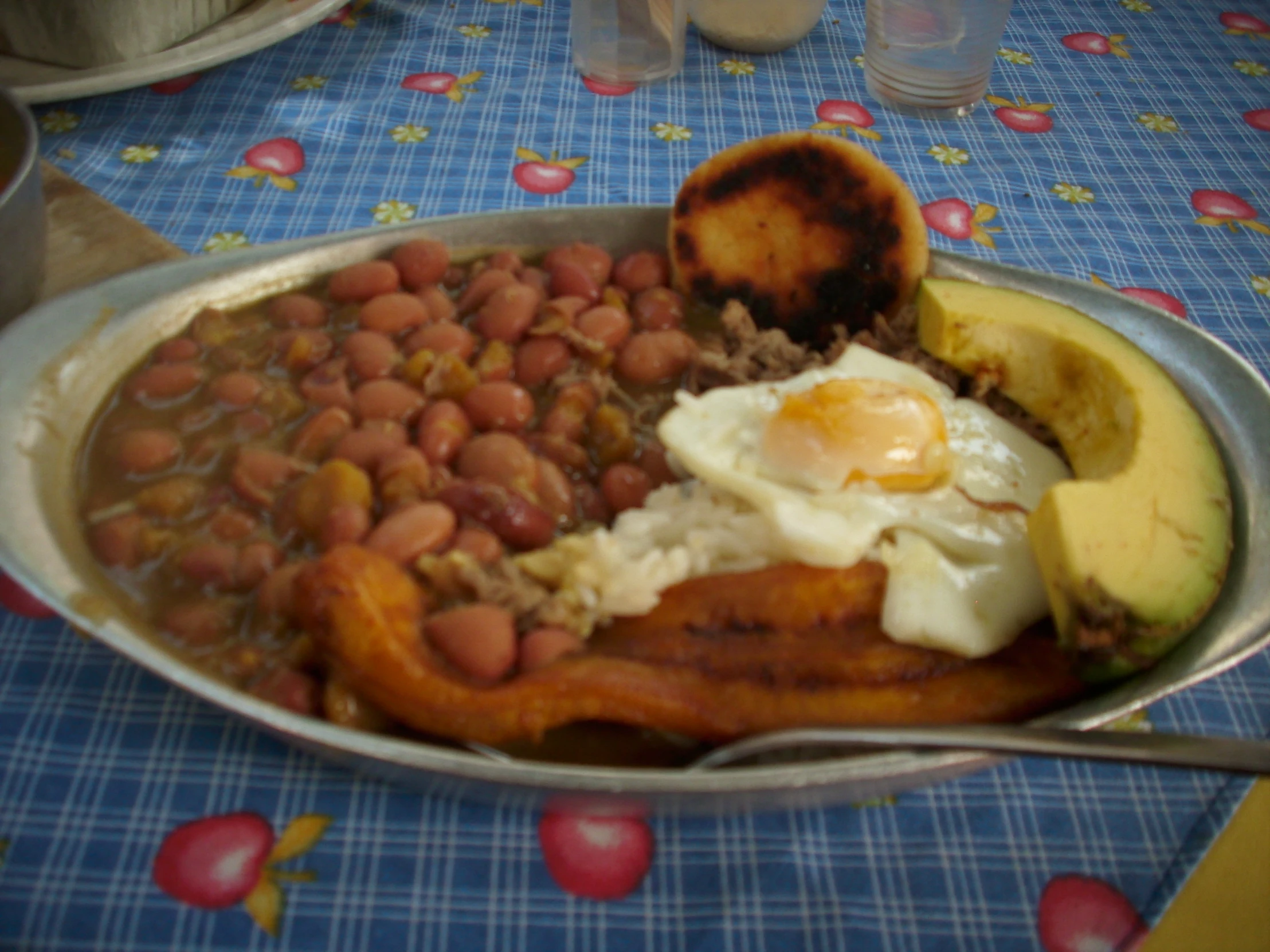 a plate of beans and eggs with avocado