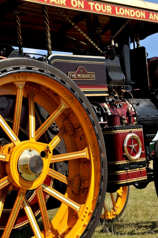 a yellow train sitting in the grass on display