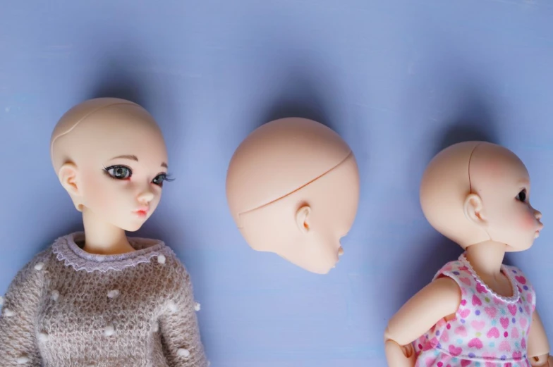 three different kinds of dolls posed for a pograph