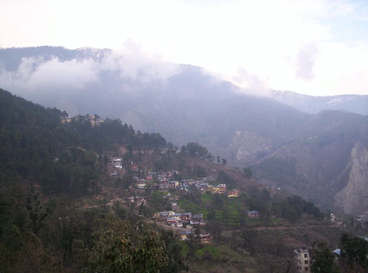 a view of a mountain town near the top of a cliff