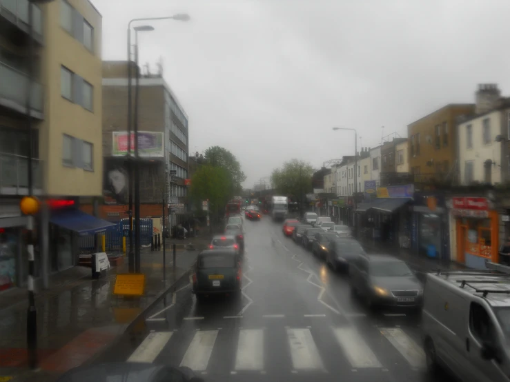 car's on an urban street in the rain