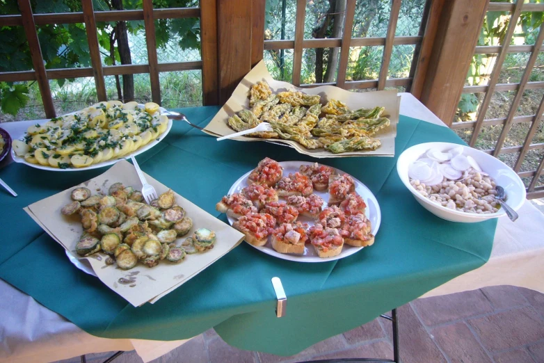 a table set up with dishes of food on it