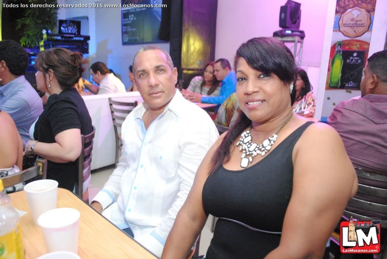 the man and woman are sitting at the table together