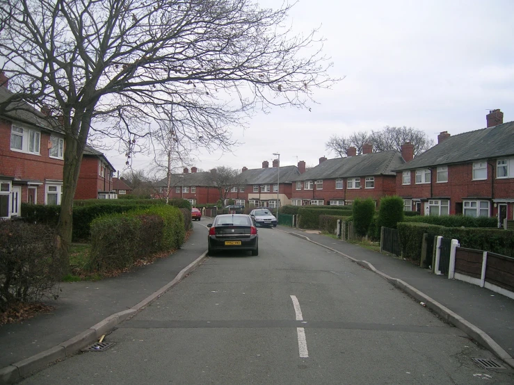 a car parked on the side of a road in front of a bunch of houses