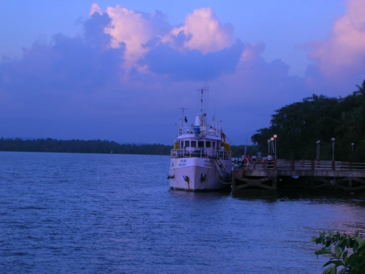 the ferry is docked at the dock in the evening