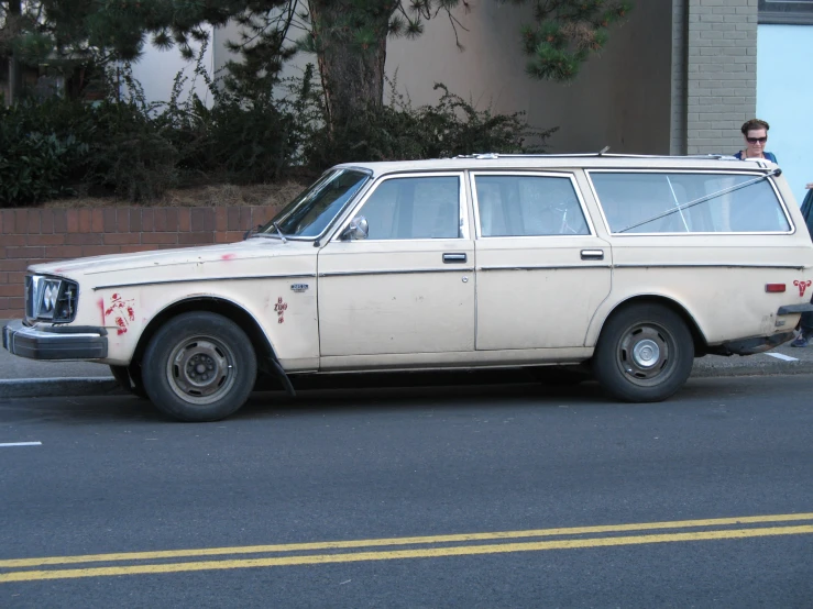 an old, worn and paint covered wagon sits on a street