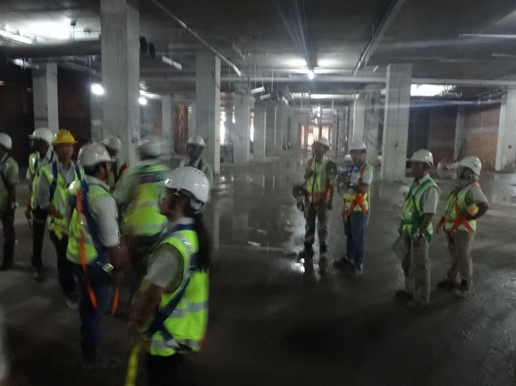 some construction workers are in a large room