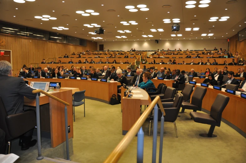 an empty meeting room filled with people sitting at their desks