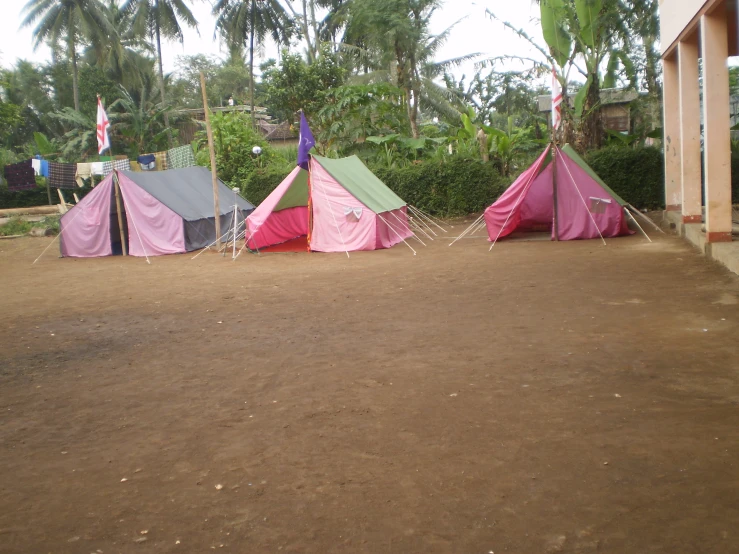 several tent in the middle of a desert lot