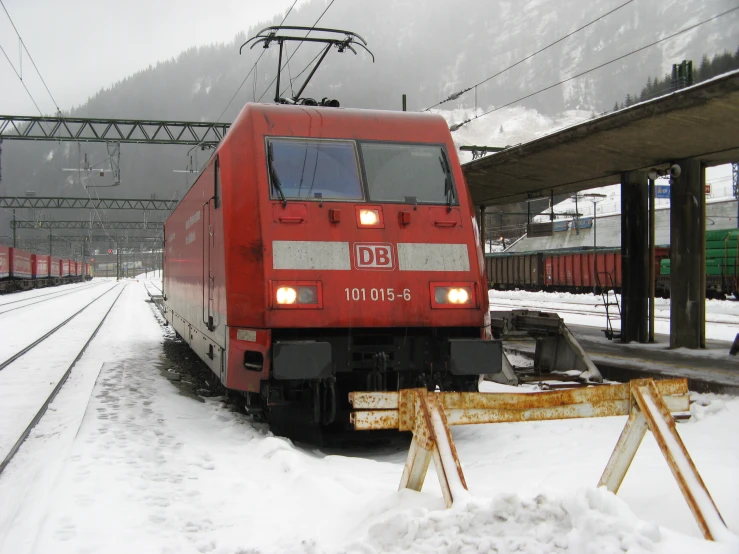 a train rides along tracks covered in snow