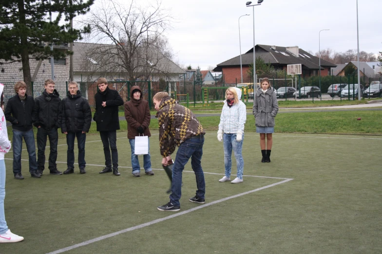 several people gather around one another to play a game of frisbee