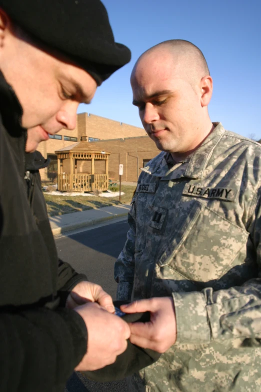 two men who are looking at their cell phones