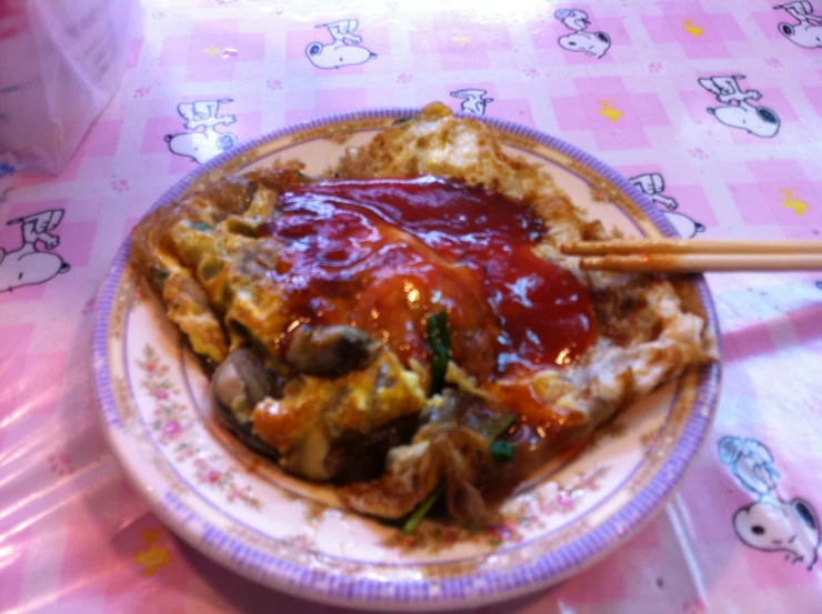 an asian breakfast entree with a chopstick on the plate