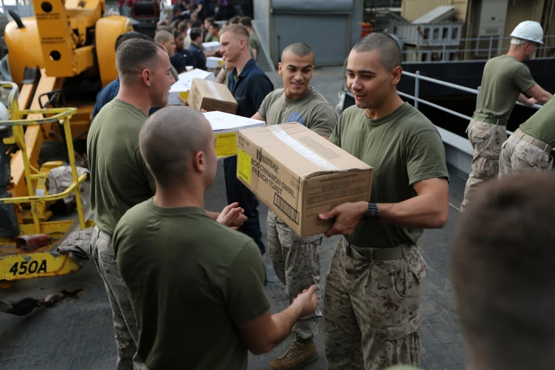 soldiers carry boxes into an open area