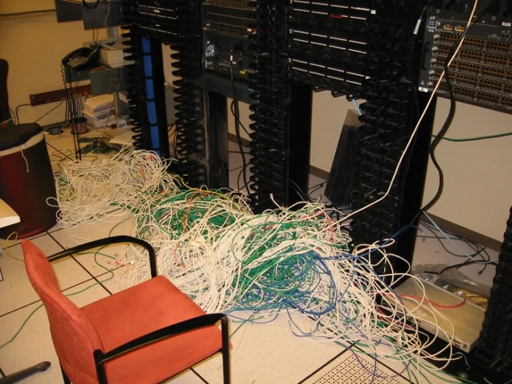 wires are tangled across the floor near chairs