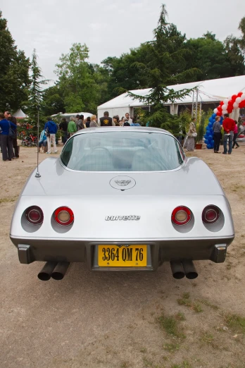 a silver vintage car with a license plate