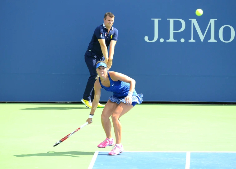 a female tennis player getting ready to hit the ball