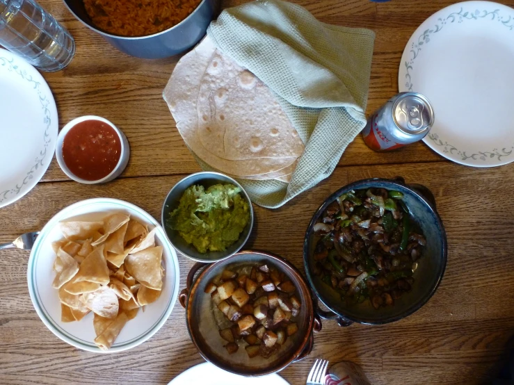 some plates and silver bowls are sitting on a table