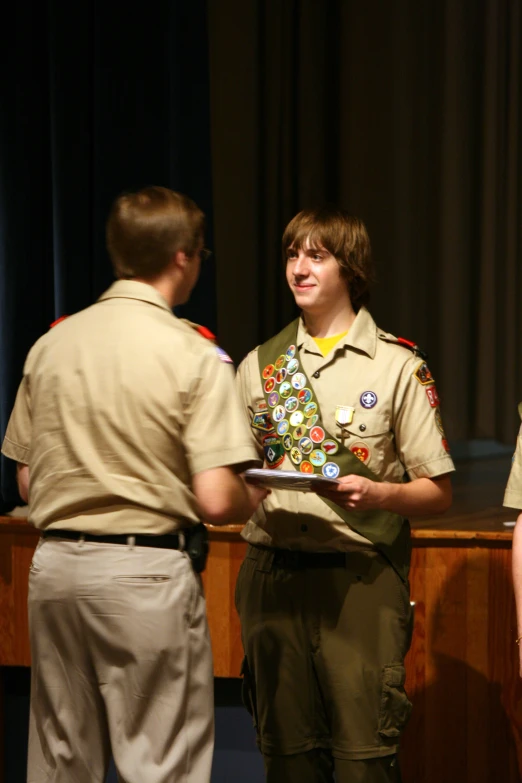 two guys are at a table in uniform