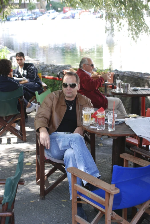 a man in a leather jacket sitting at a table
