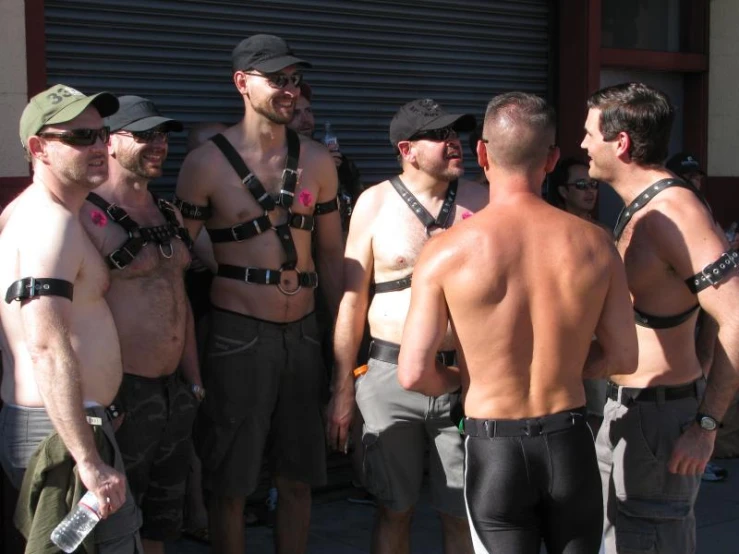 men wearing a leather outfit standing around each other