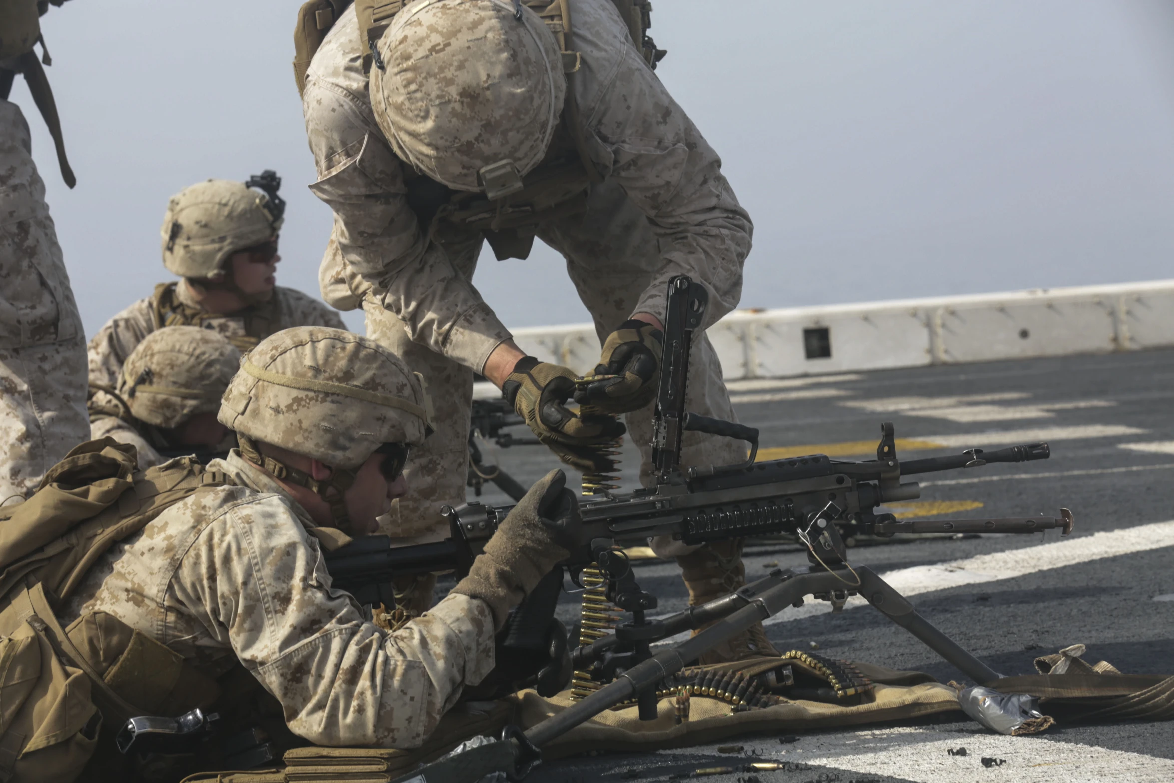 three men in uniform are on the ground