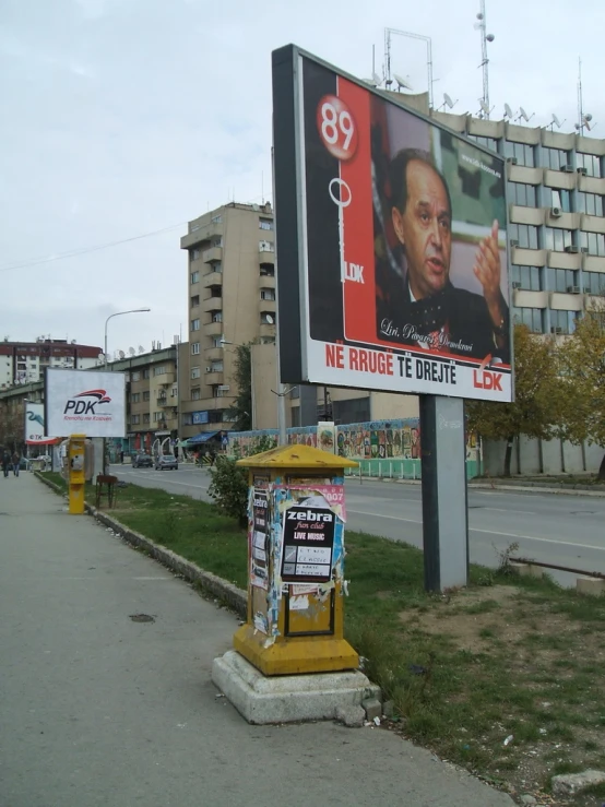 a newspaper dispenser on the side of the road