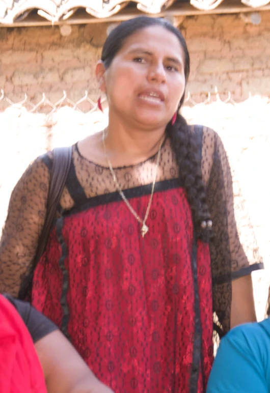 a woman in a red dress standing near two women