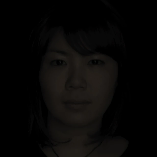 the head of an asian woman is shown in the dark