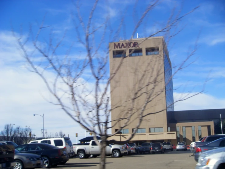 a view of a building at the entrance to a parking lot