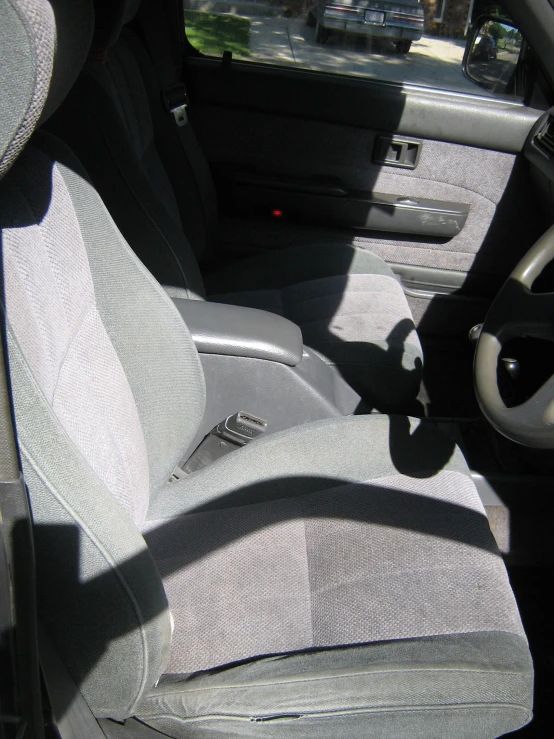 interior of automobile showing two white seats in middle