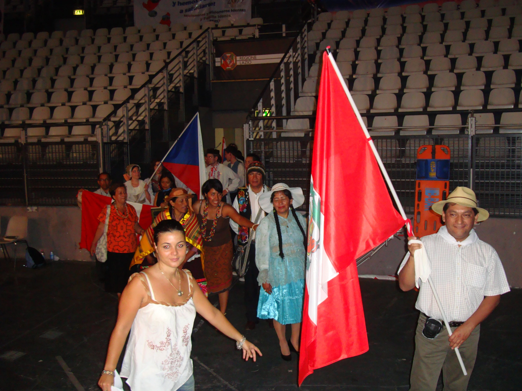 several people standing in a row, and some are carrying flags