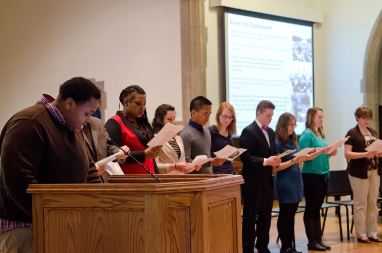 a group of people standing in front of a podium