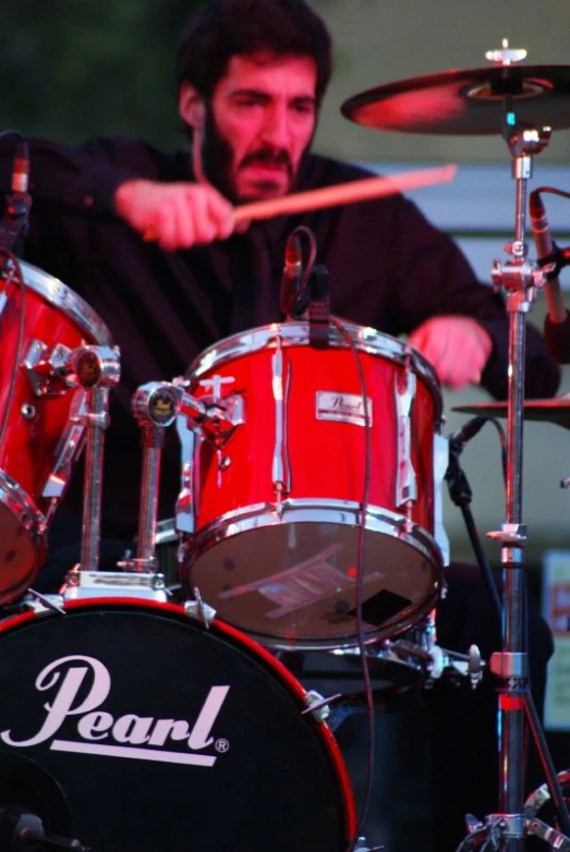 a man is playing drums on stage