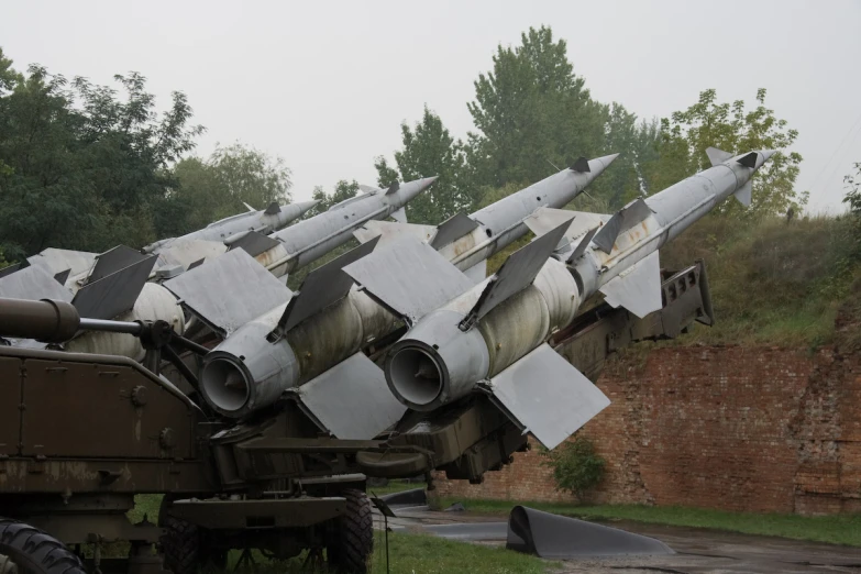 several army vehicles with metal surfaces attached to them