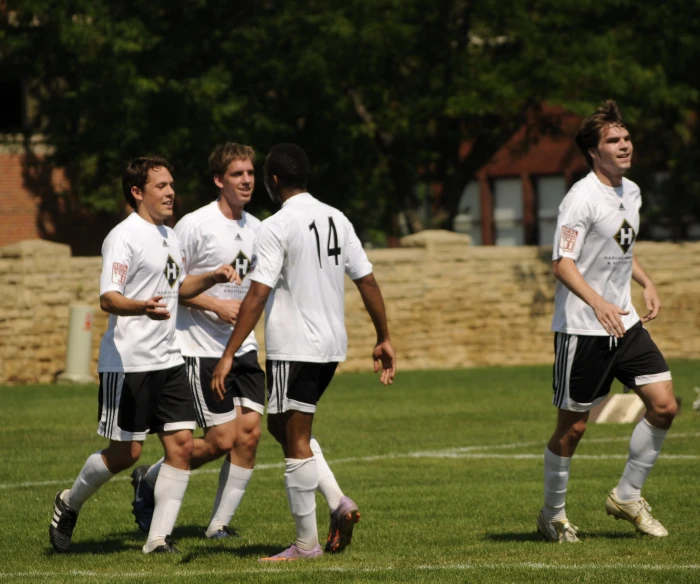 a group of men playing soccer against each other