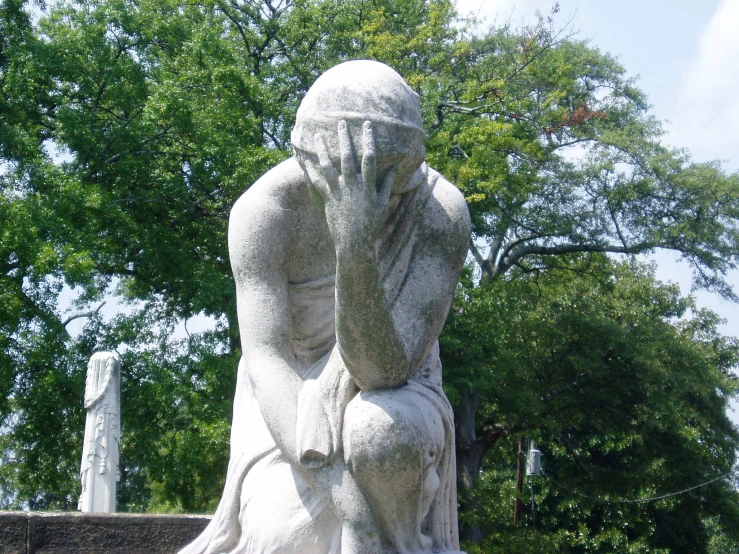 the woman statue is made of white marble