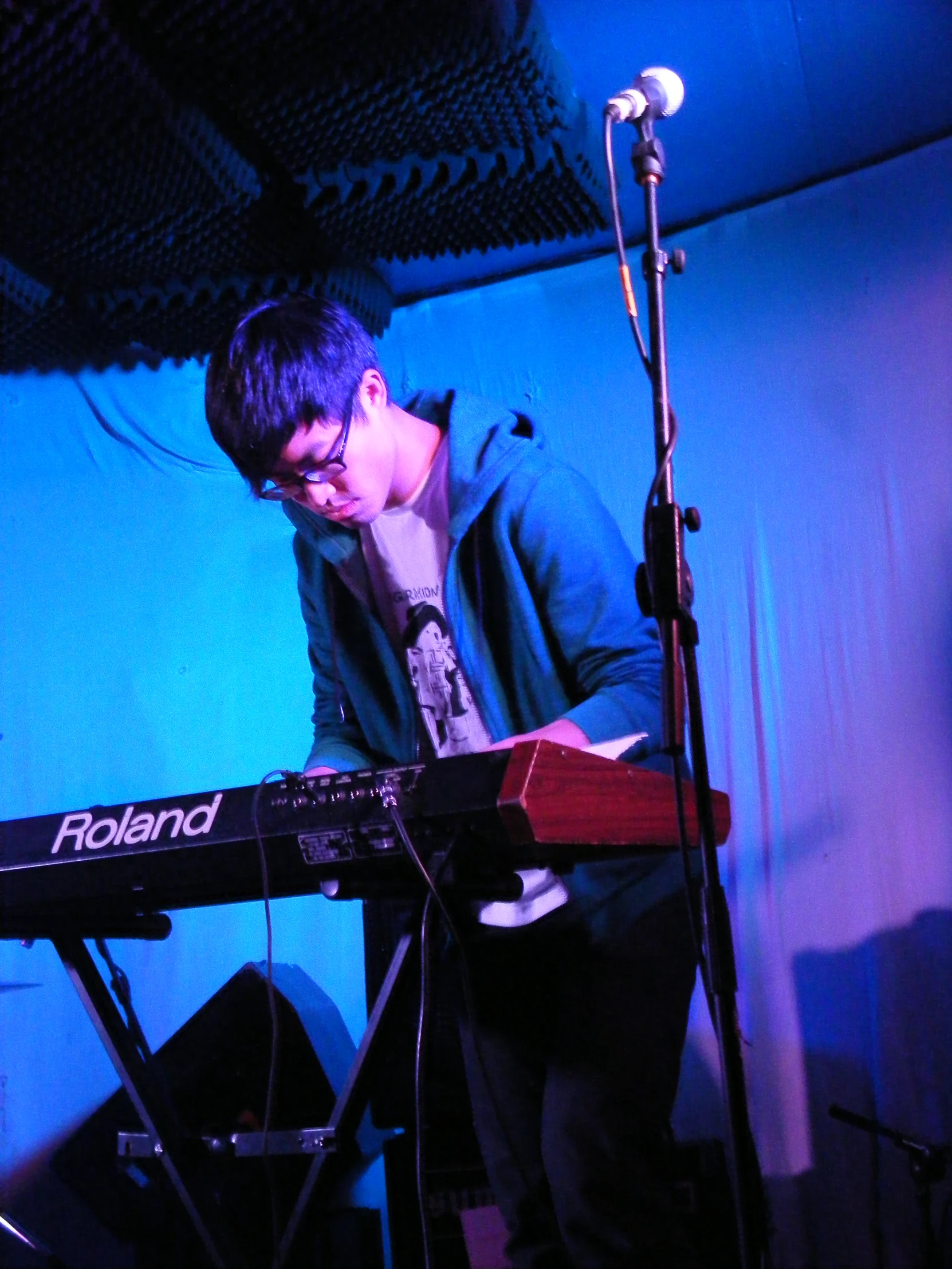 a man with headphones on playing a music keyboard