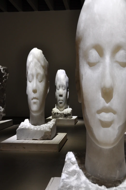 sculptures of women are on display in a museum