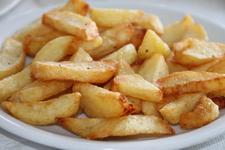 there are slices of french fries that is on a plate