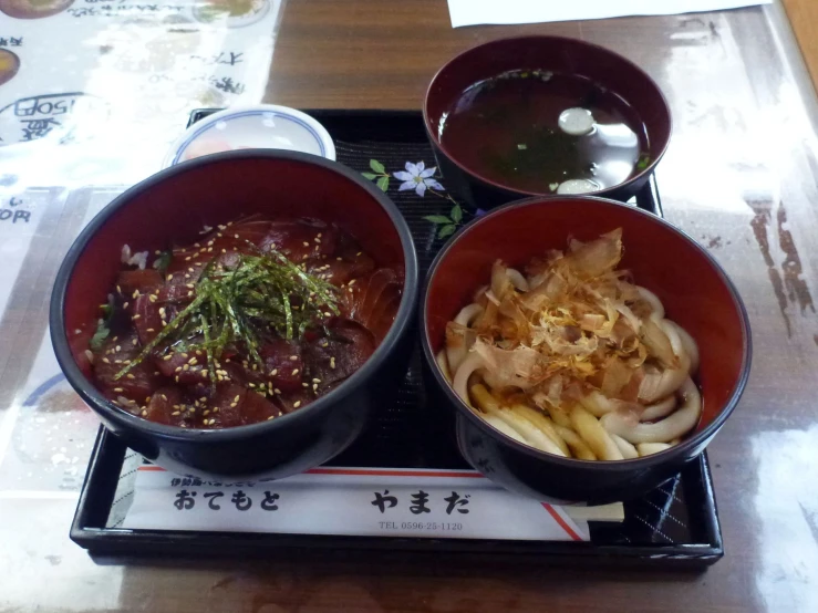 two bowls of food are shown on a tray