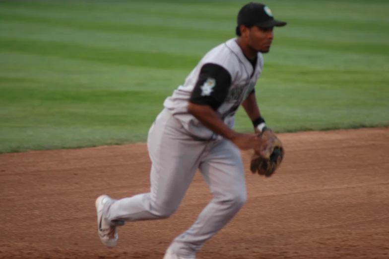 a baseball player catching the ball while running down a field