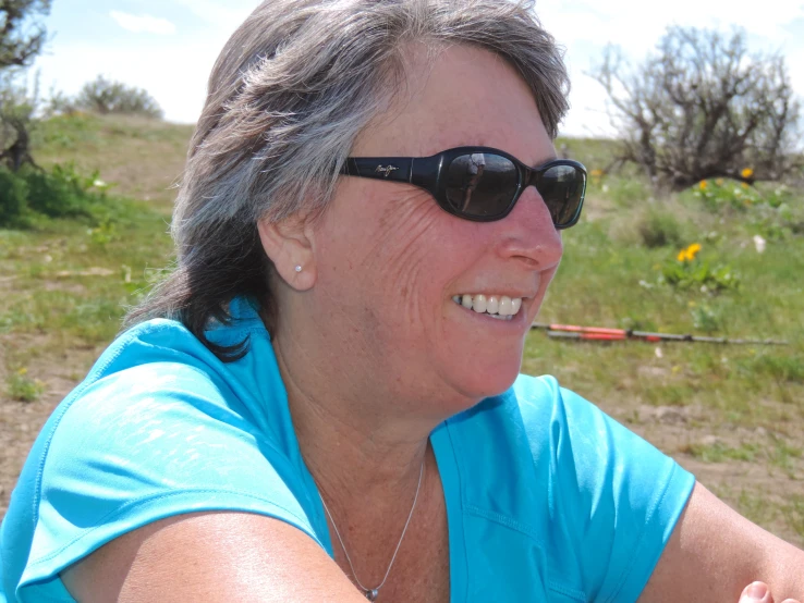 woman smiling in front of an open field