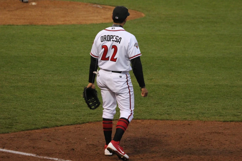 baseball player with ball in his hand standing on a field