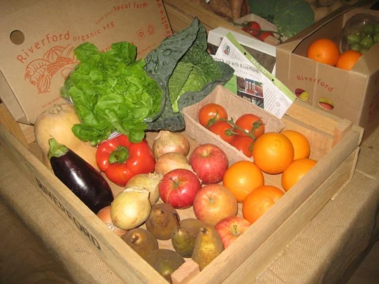 a cardboard box with fruits and vegetables on it