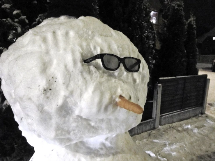 a snowman has a cigarette in its mouth