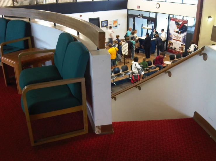 there is a hallway in an office with chairs and tables