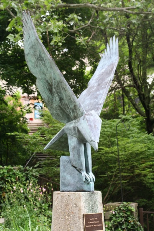 a statue of a bird flying on it's head