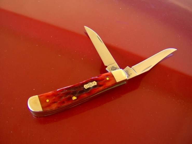 a pair of knives with red and yellow handle